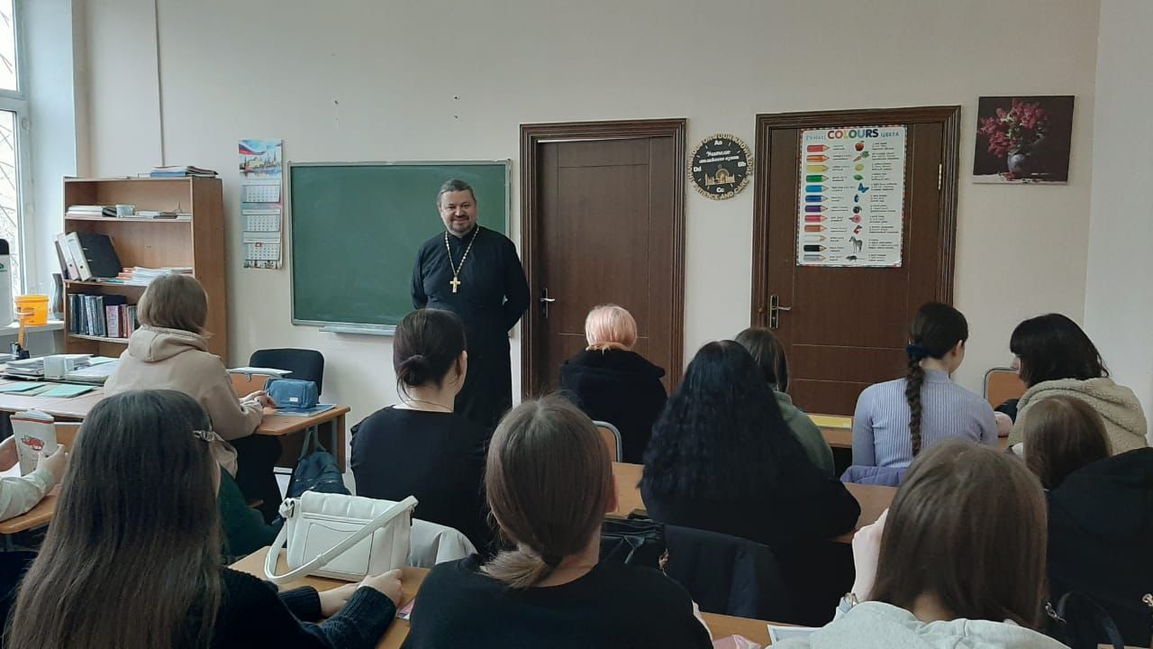 Разговор священника со студентами колледжа.